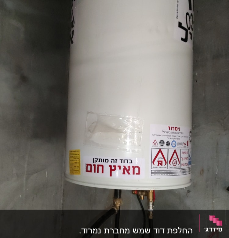 דוד שמש עם צינורות חיבור ומדבקות אזהרה